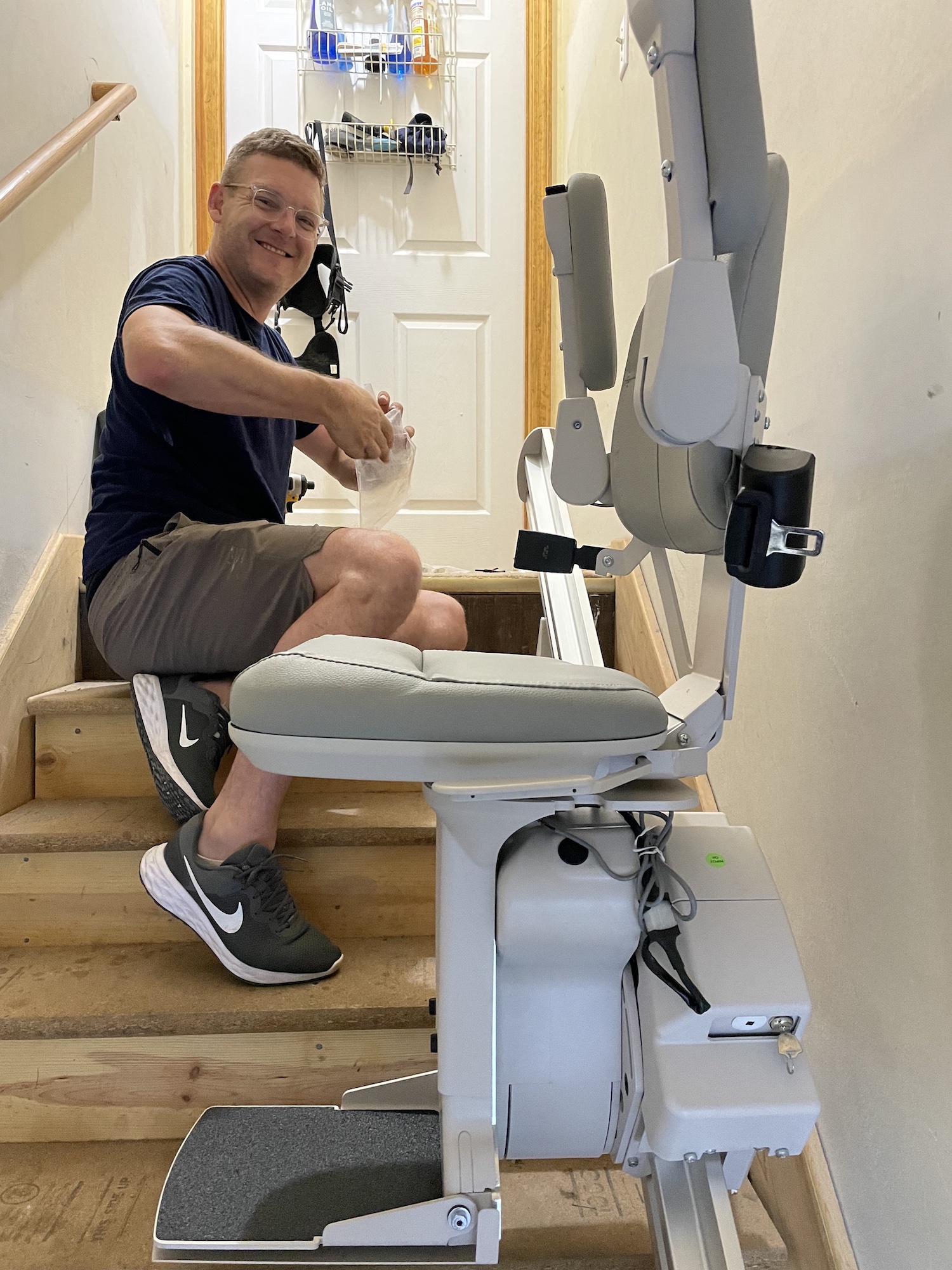 man doing work on a stair lift